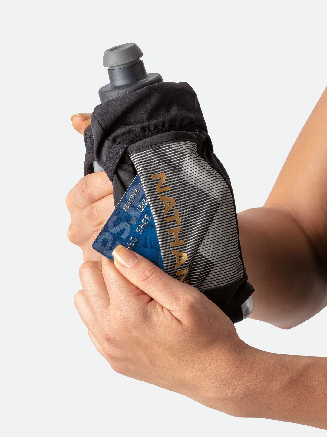 Nathan Running Handheld insulated bottle 12oz-18oz demonstrates temperature-retaining versatility outdoors.