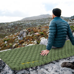 Naturehike 25oz ultralight sleeping pad inflates on trail, delivering compact warmth and comfort.