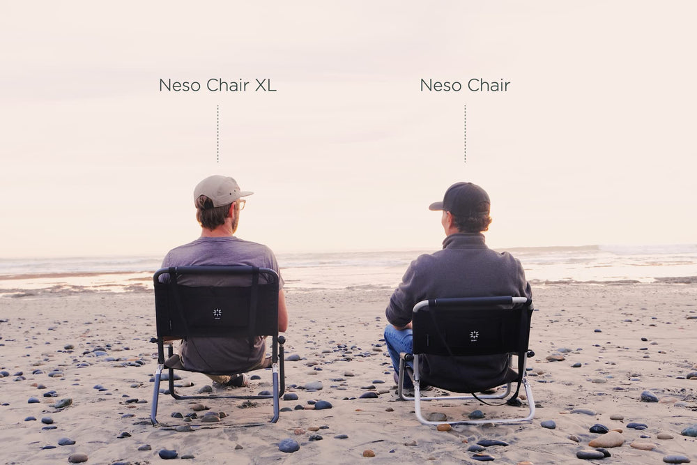 Neso Aqua Fronds chair on sandy beach invites relaxed lounging and shade.