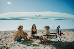 Neso Beach Table cup holders and pockets keep essentials within reach.