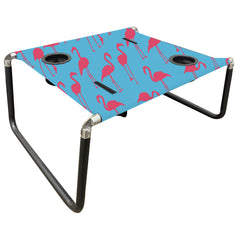 Neso Beach Table setup with flamingos keeps drinks within reach on the sand