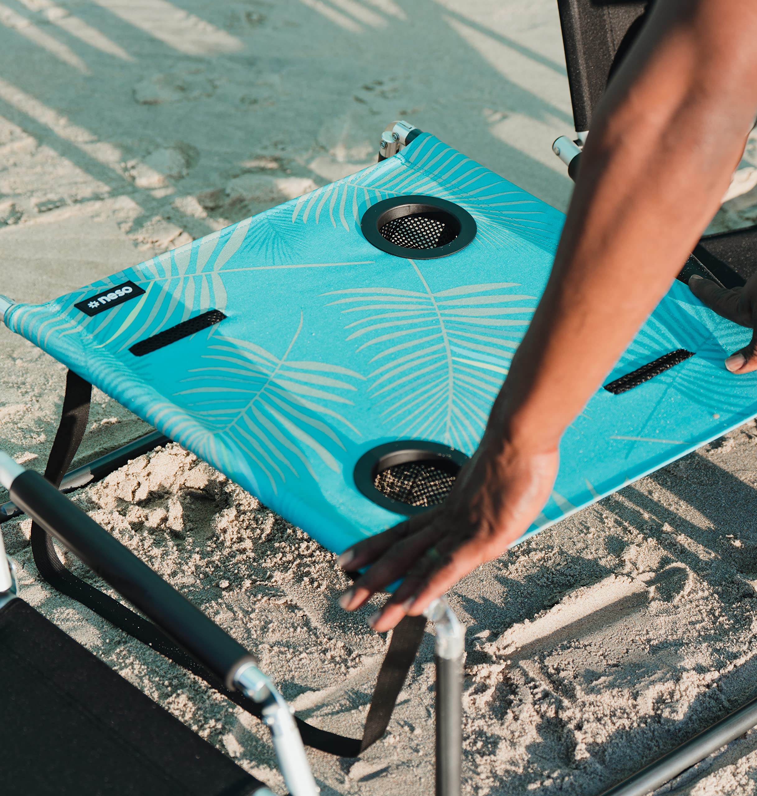 Neso Beach Table shoulder strap enables hands-free transport.