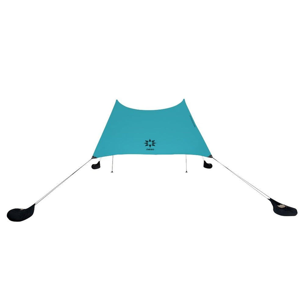 Neso Grande sun shelter setup shows easy assembly and wide shade coverage for family beach days.