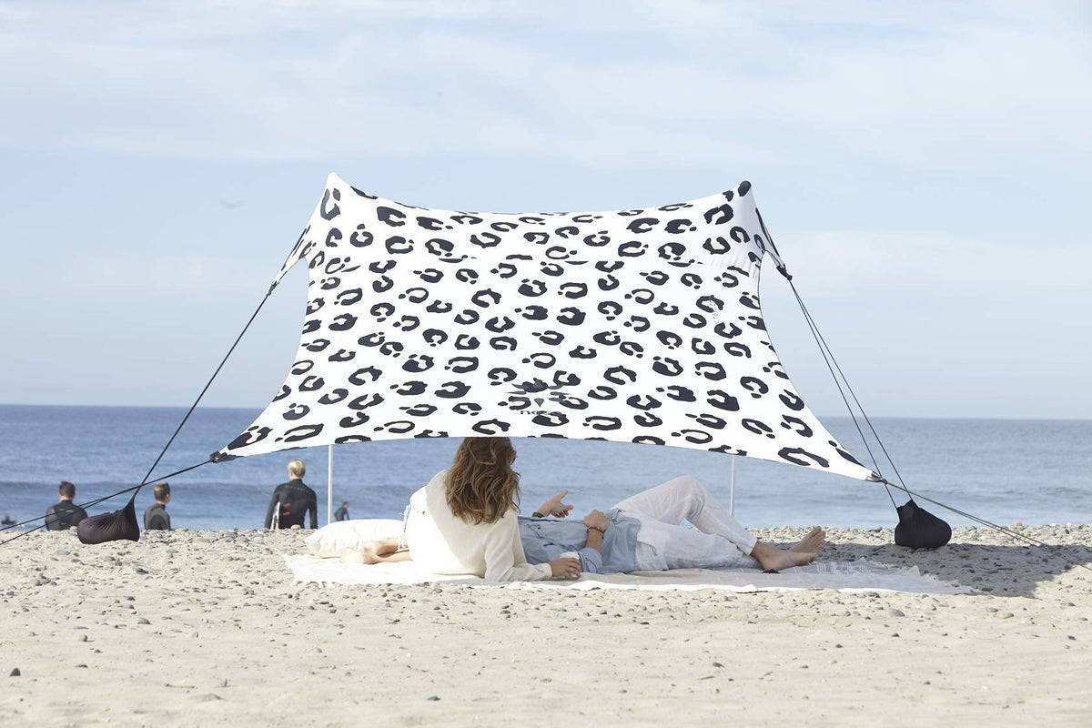 Neso Leopard tent assembled on the beach delivering quick shade and airflow.