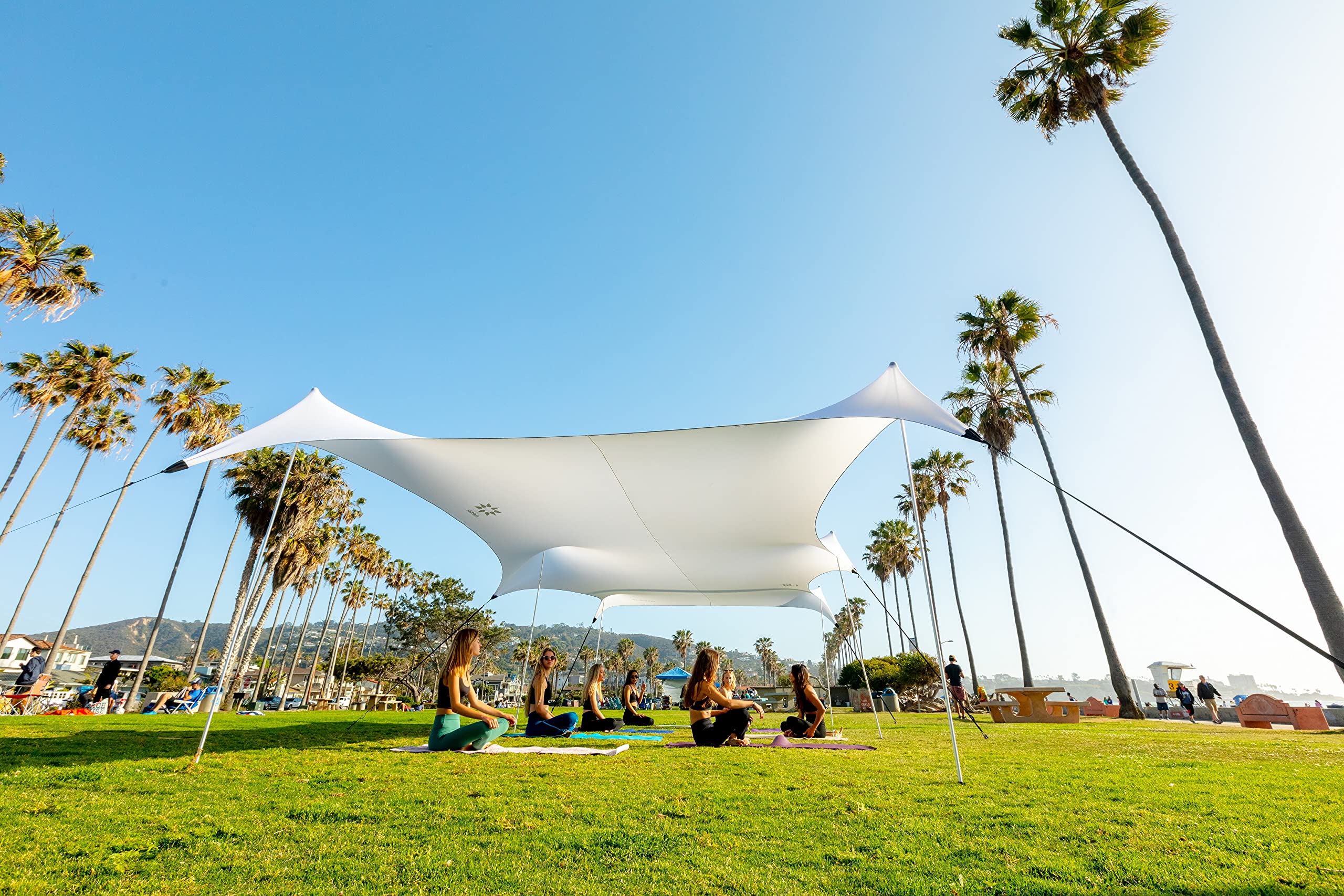 Neso Party Tent 11x22ft on the beach, stable shade for sun and wind.