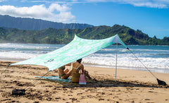 Neso sand anchor bags in action providing stable shade on windy days.