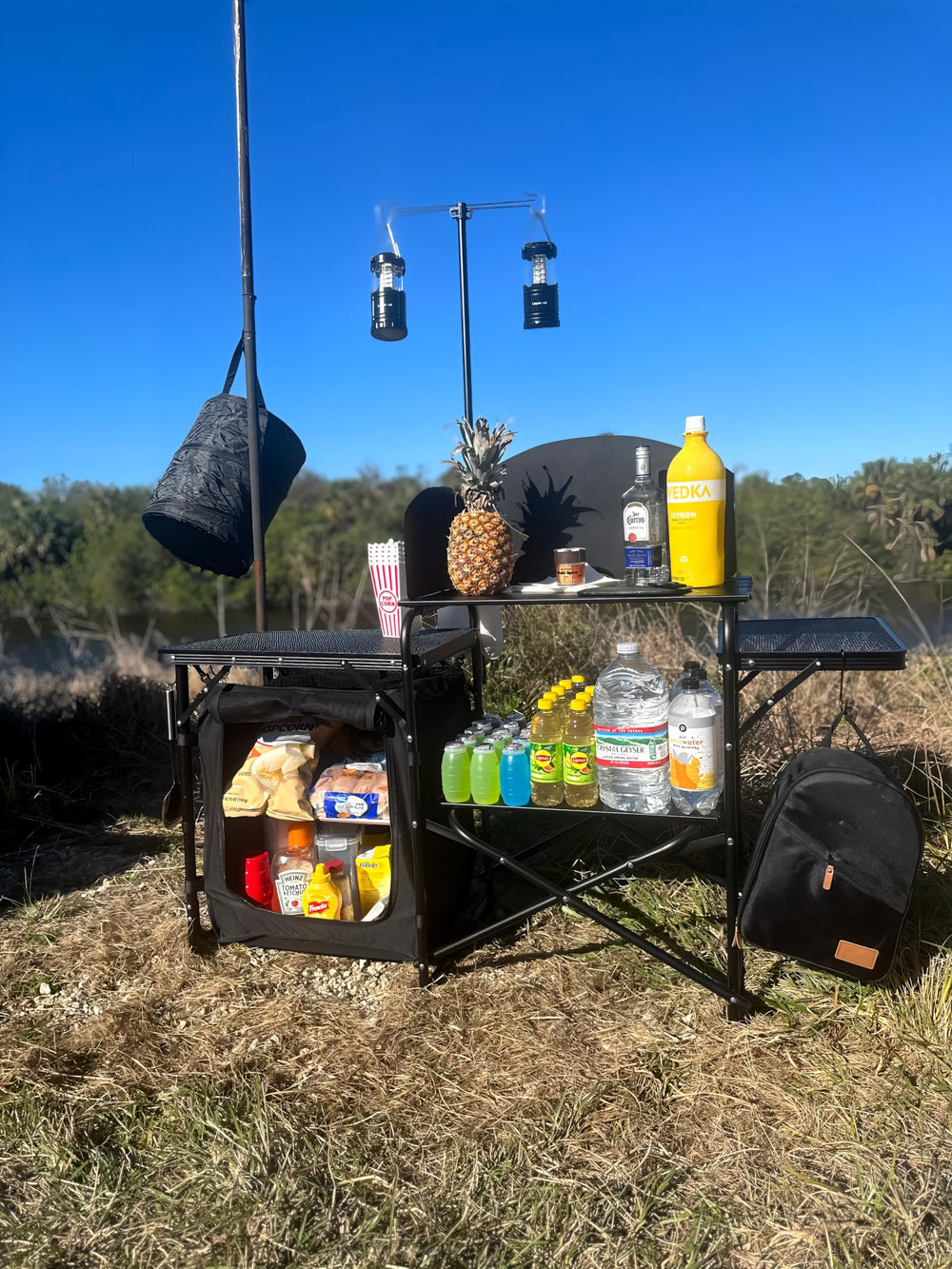 Nice C camping kitchen station light-stand-windshield demonstrates windproof cooking at campsite.