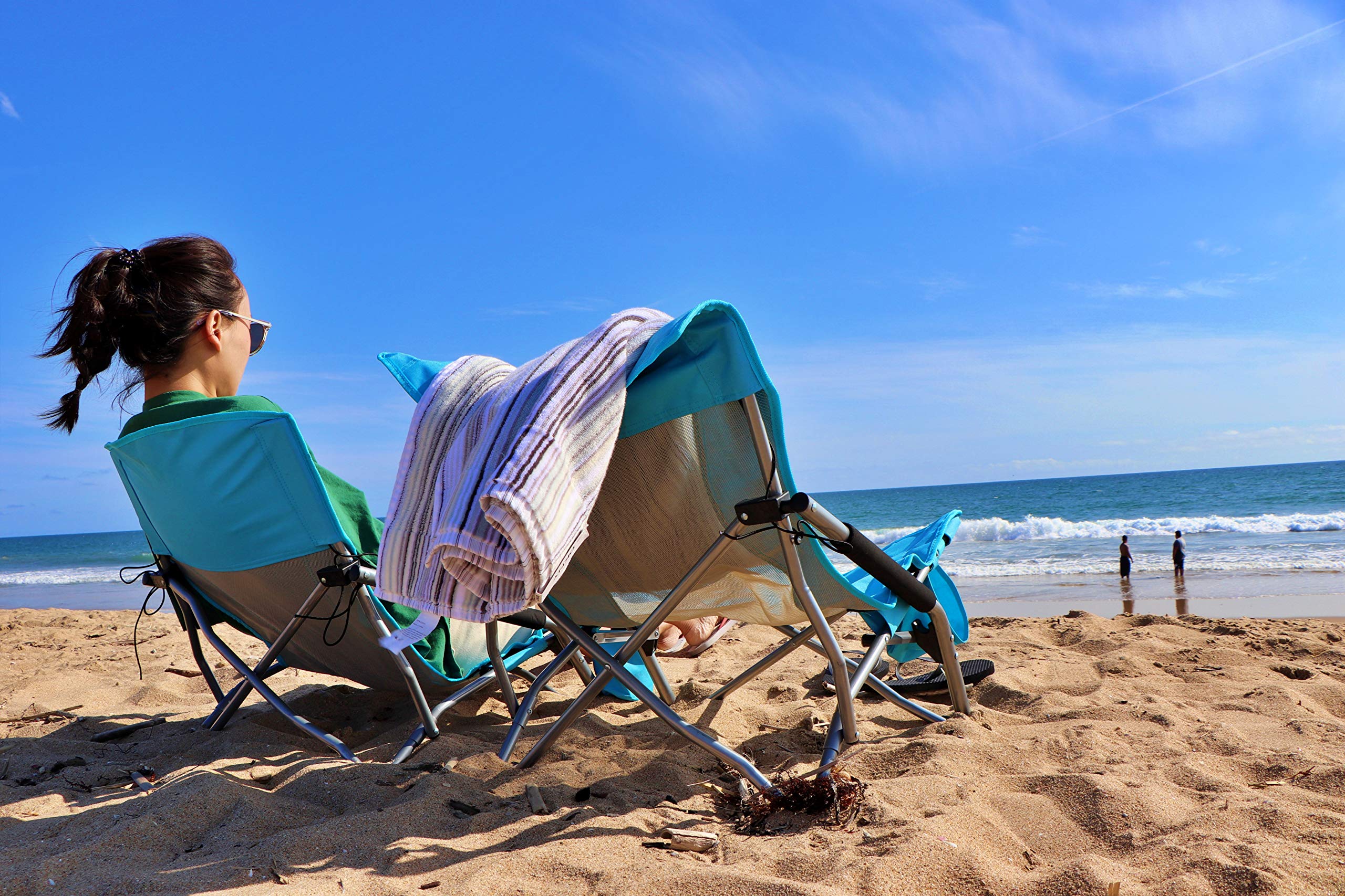 Nice C low beach chair open blue comfortable low-profile seating for lounging.