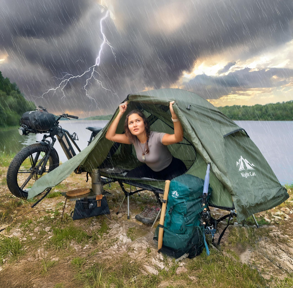 Night Cat cot tent with guylines stabilizing against wind