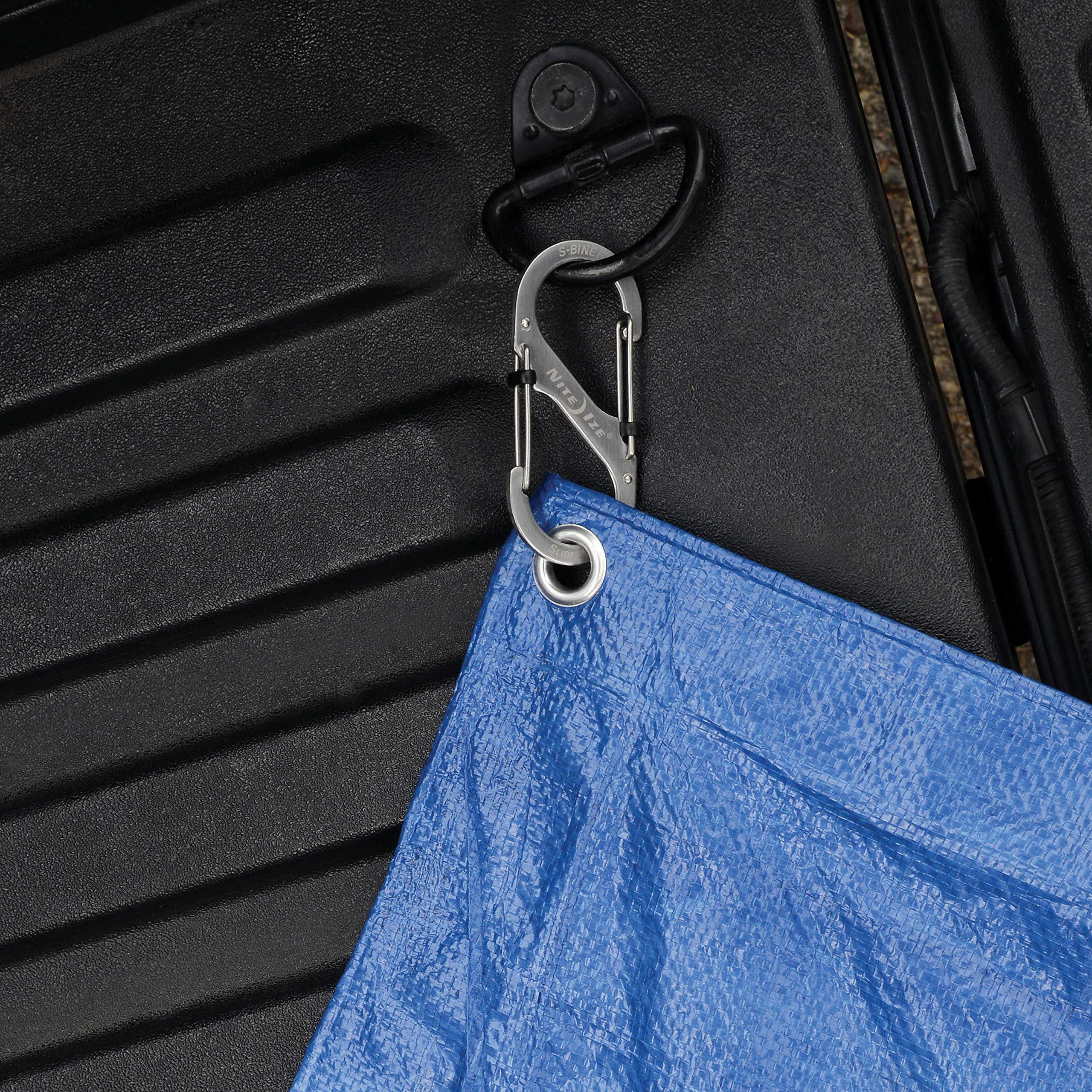 Nite Ize carabiner clip holding tools in silver for reliable grip
