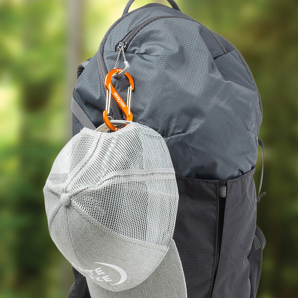 Nite Ize S-Biner clipping zipper pulls on luggage for smooth operation.
