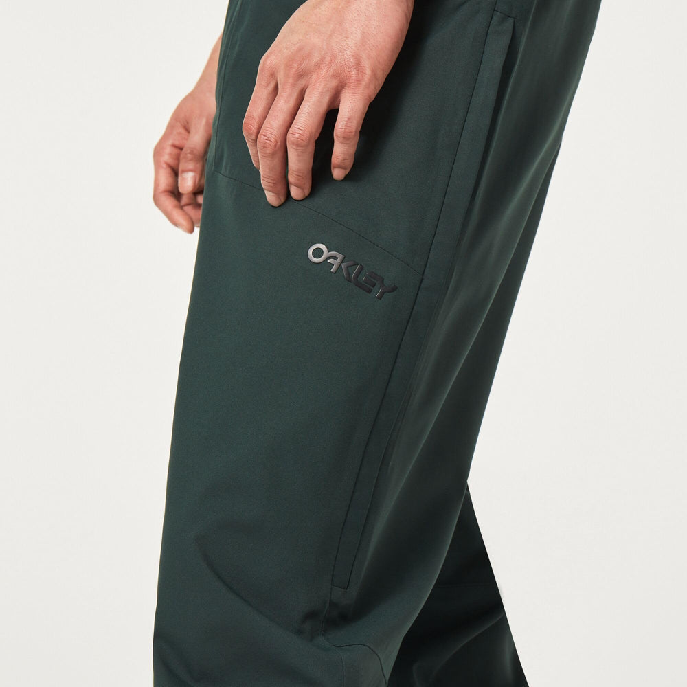 Oakley TNP Evoke RC Shell Pant model wear showcases modern styling for outdoor wear.
