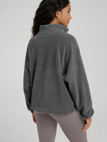 ODODOS Women's Polar Fleece Full-Zip Jacket side view demonstrates cinchable-hem for adjustable fit.