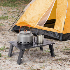 Old Bahama Bay Ultralight Mini Table extended on a sandy beach for stable outdoor dining.