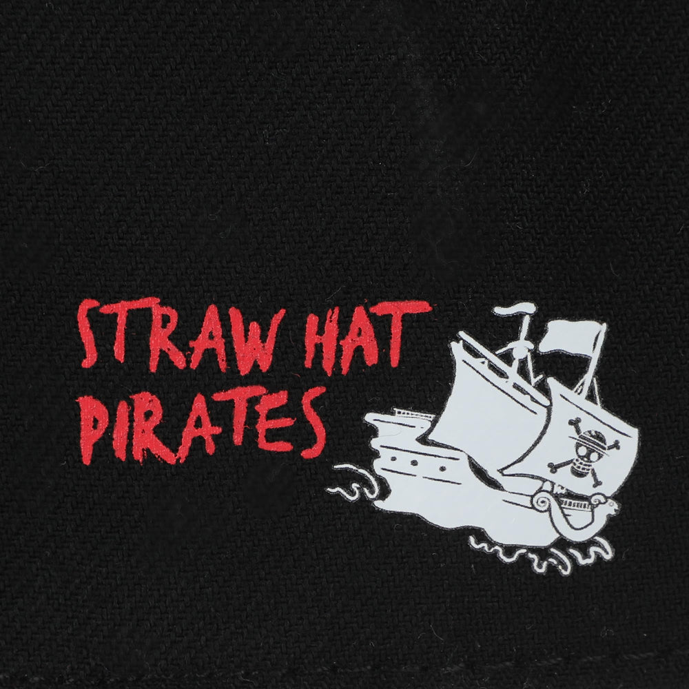 Side profile showing adjustable strap on black snapback hat