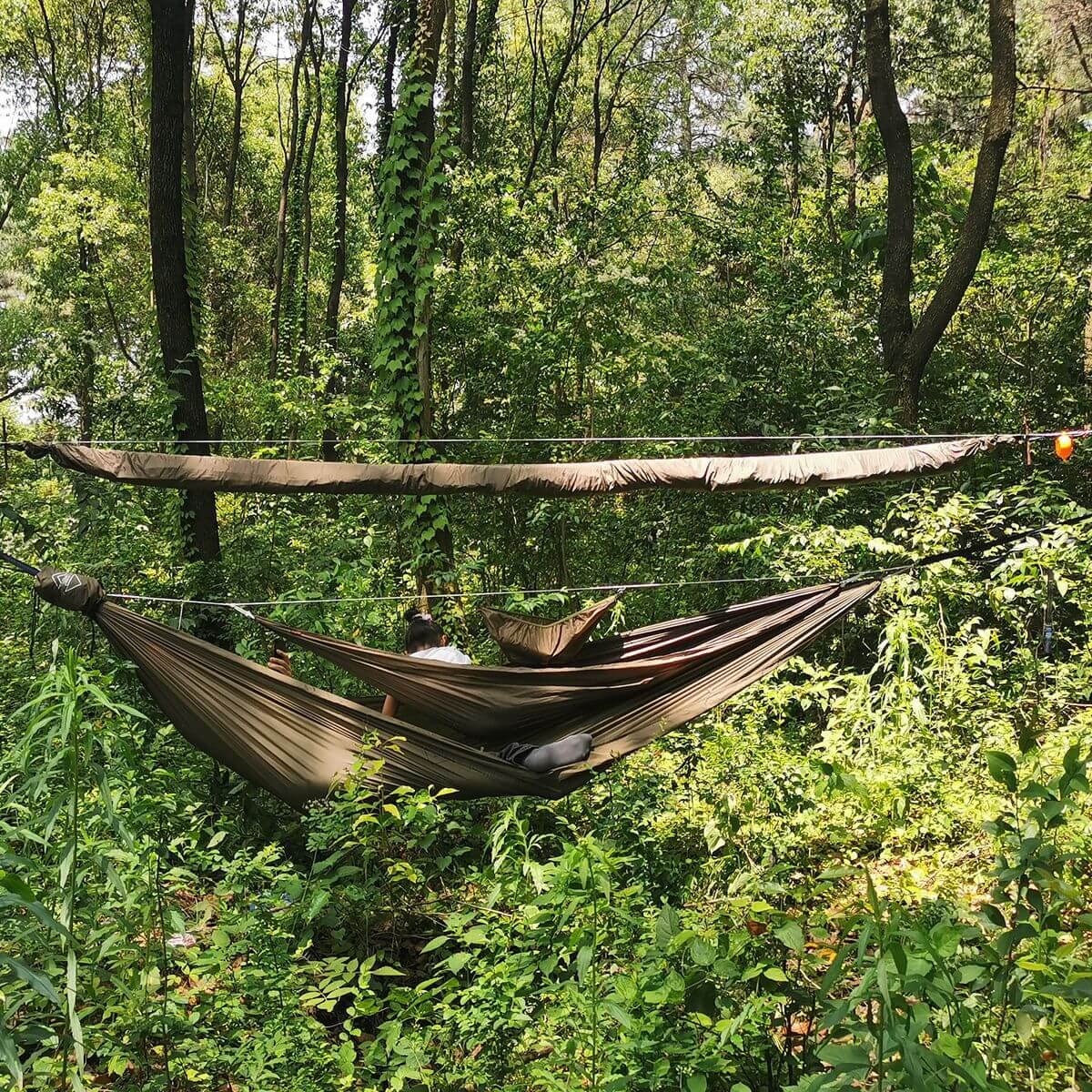Onewind Peak Storage Hammock in use keeps gear organized above the hammock.