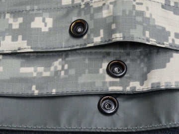 ORC USGI tarp ACU foliage sand side edge, durable grommets and snaps ready for setup.