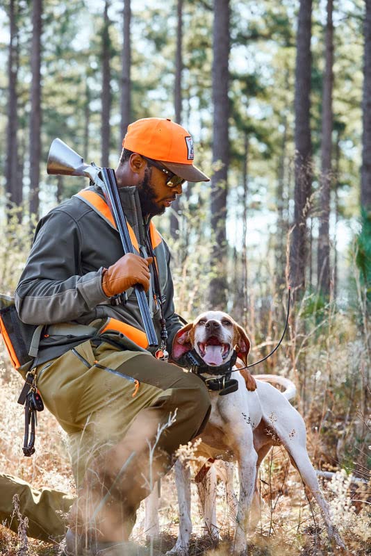 Model wearing Orvis Uplander gloves in rugged upland terrain