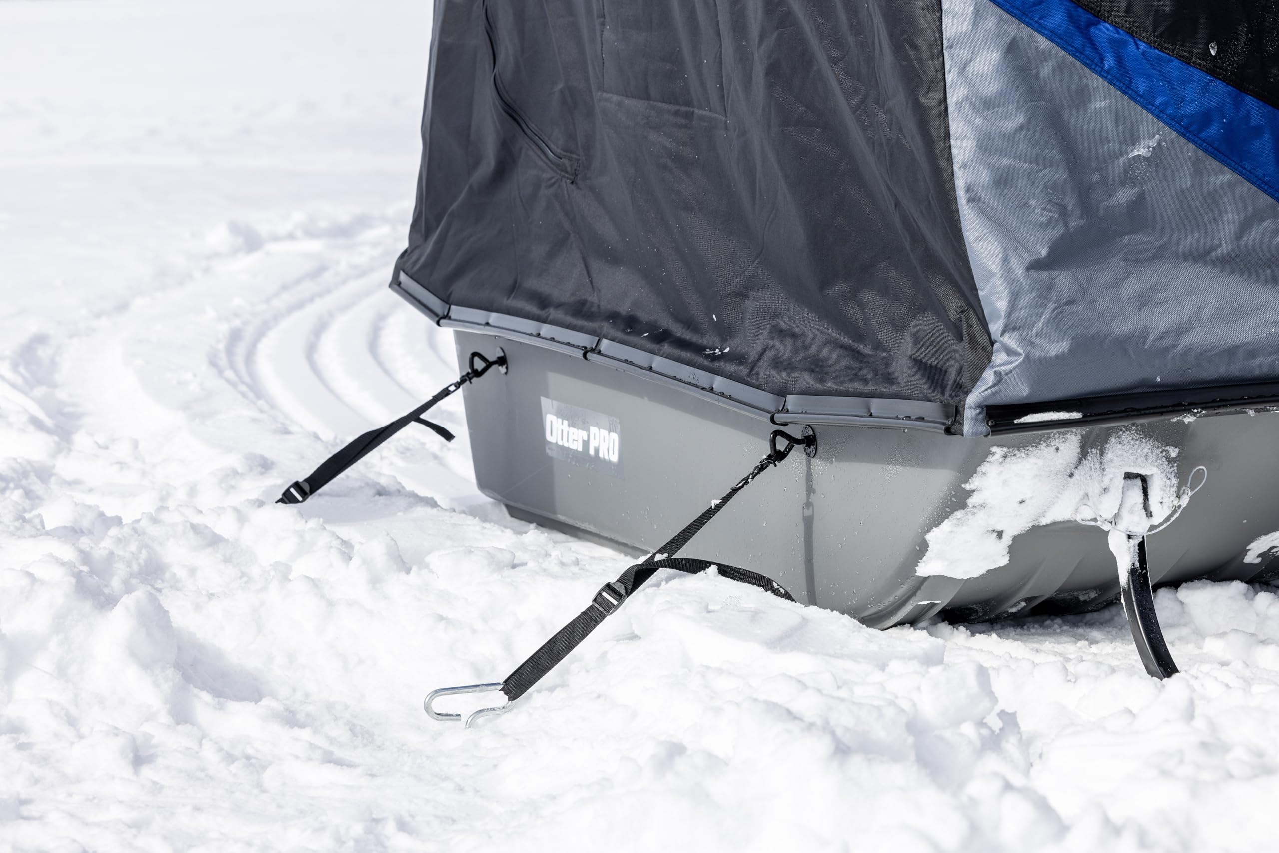 OTTER Sled Anchor Kit quick-release straps securing a sled on icy wind