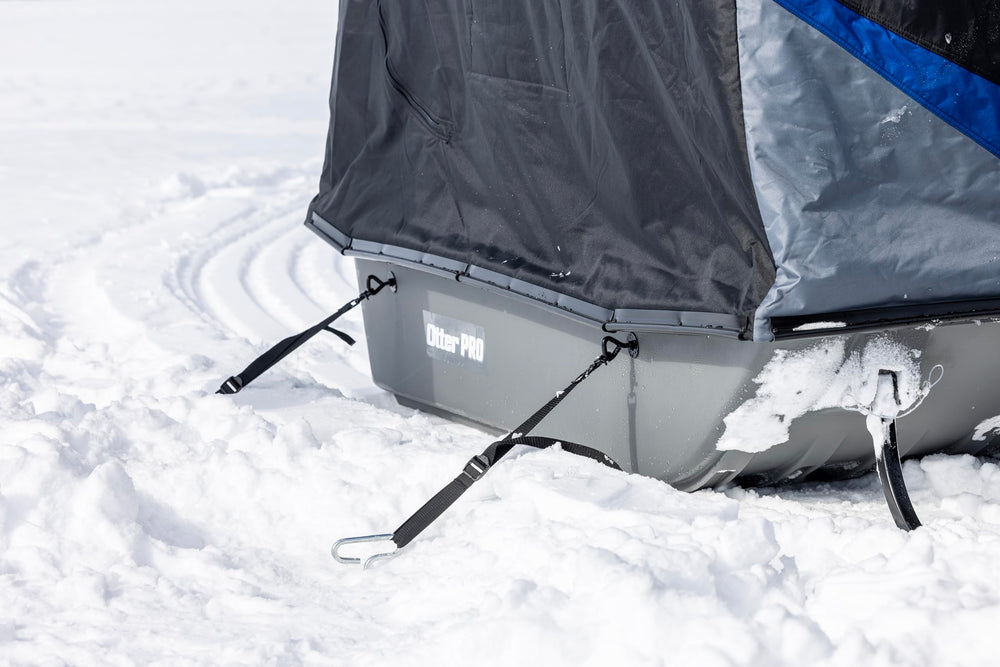 OTTER Sled Anchor Kit quick-release straps securing a sled on icy wind