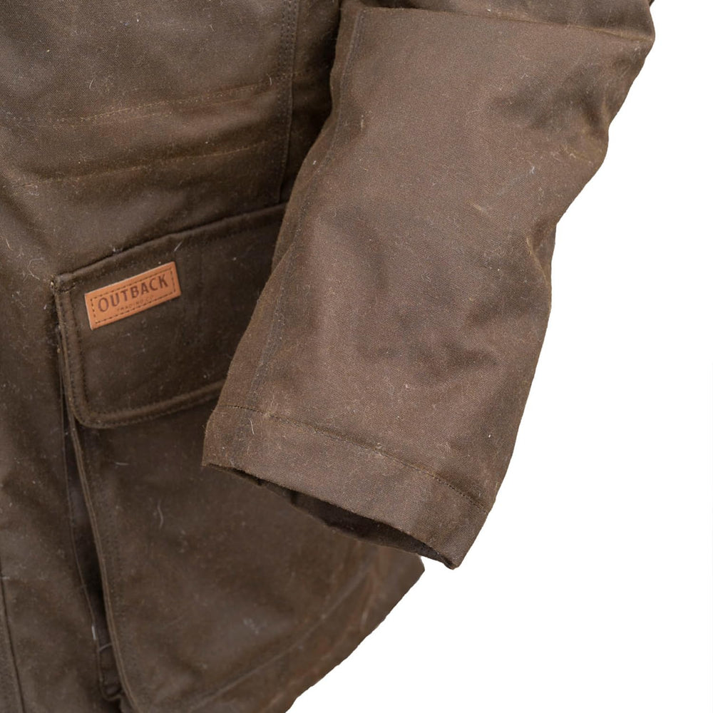 Outback Nolan Bronze side view highlights storm flap and convenient pockets in windy conditions.