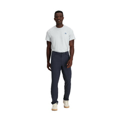 Outdoor Research Ferrosi Transit Pants in motion on a rocky path for versatile outdoor use.