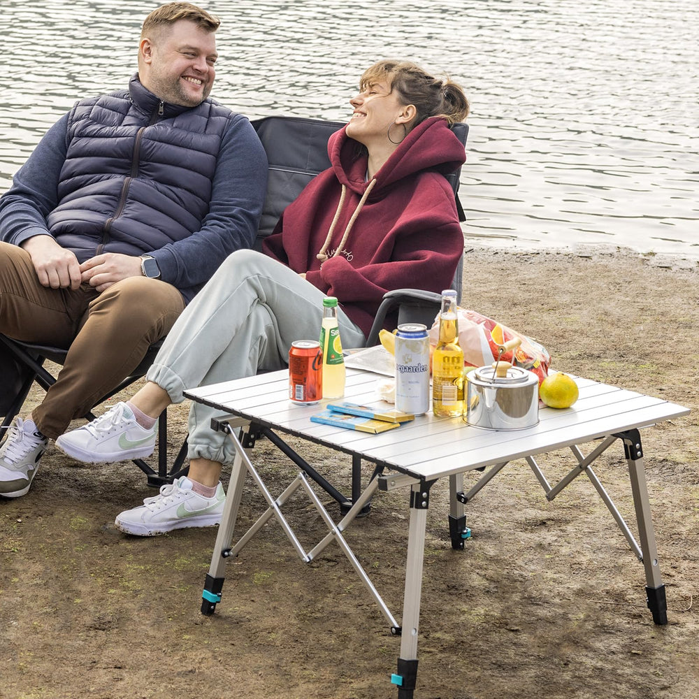 OuterSpa portable camping table setup on uneven terrain showing adjustable legs