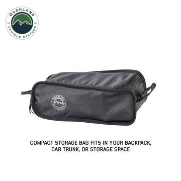 Overland Vehicle Systems Compact Camping Chair at a picnic setup for relaxed seating.