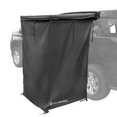 Overland Vehicle Systems XD Nomadic shower awning mounted on a vehicle for quick outdoor setup.