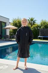 Owntop Surf Coat waterproof outer shell demonstrates dryness for beach or pool side outfits.