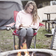 Ozark Trail folding chair red folded for storage, compact design for travel.