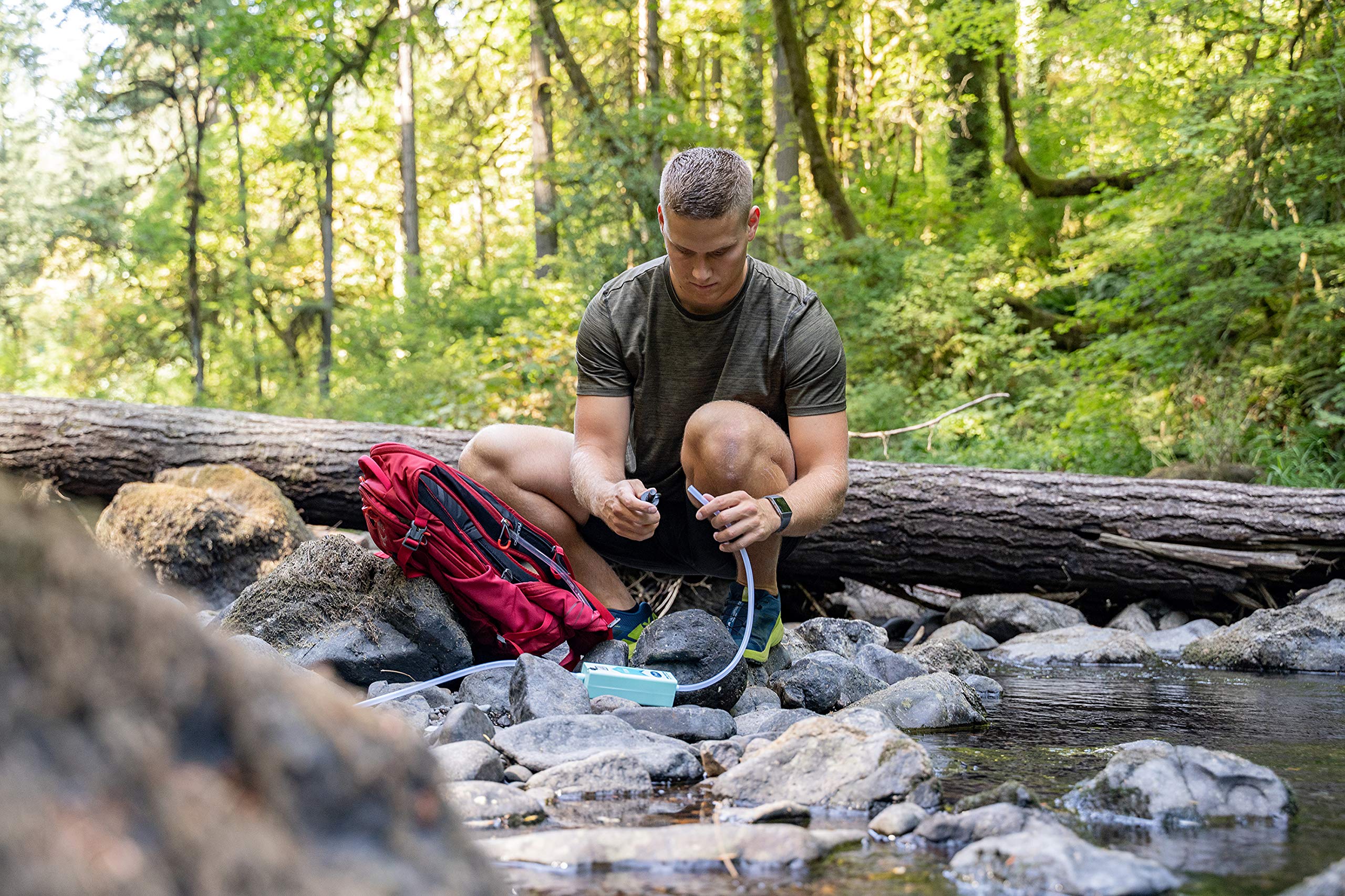 Pacific Bay pump shown in outdoor use for hiking and camping water needs.