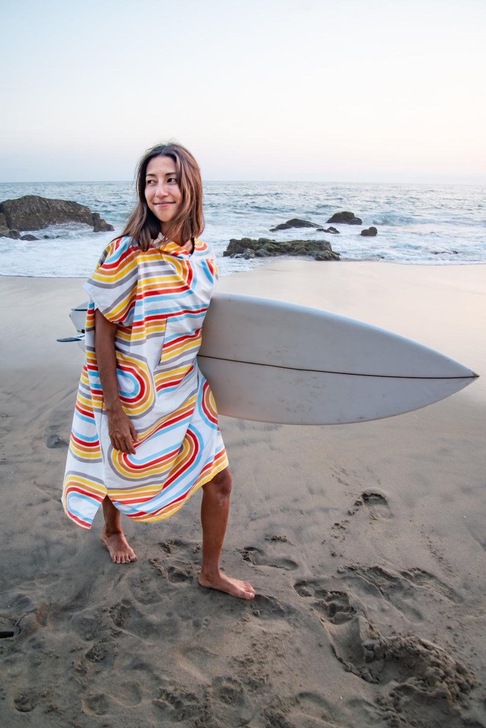 PackTowl hooded poncho silhouette enabling easy changing in outdoor settings