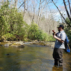 Paramount Outdoors Fast Eddy waist-high wader pant gravel guards protecting stockingfoot booties in rugged terrain.