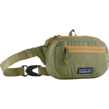 Patagonia Ultralight Black Hole Mini Hip Pack worn at the waist for lightweight, secure storage.