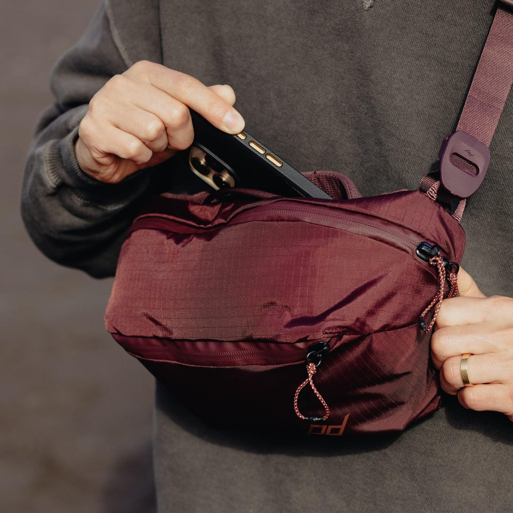 Peak Design Outdoor Sling 2L Eclipse worn as crossbody for quick access