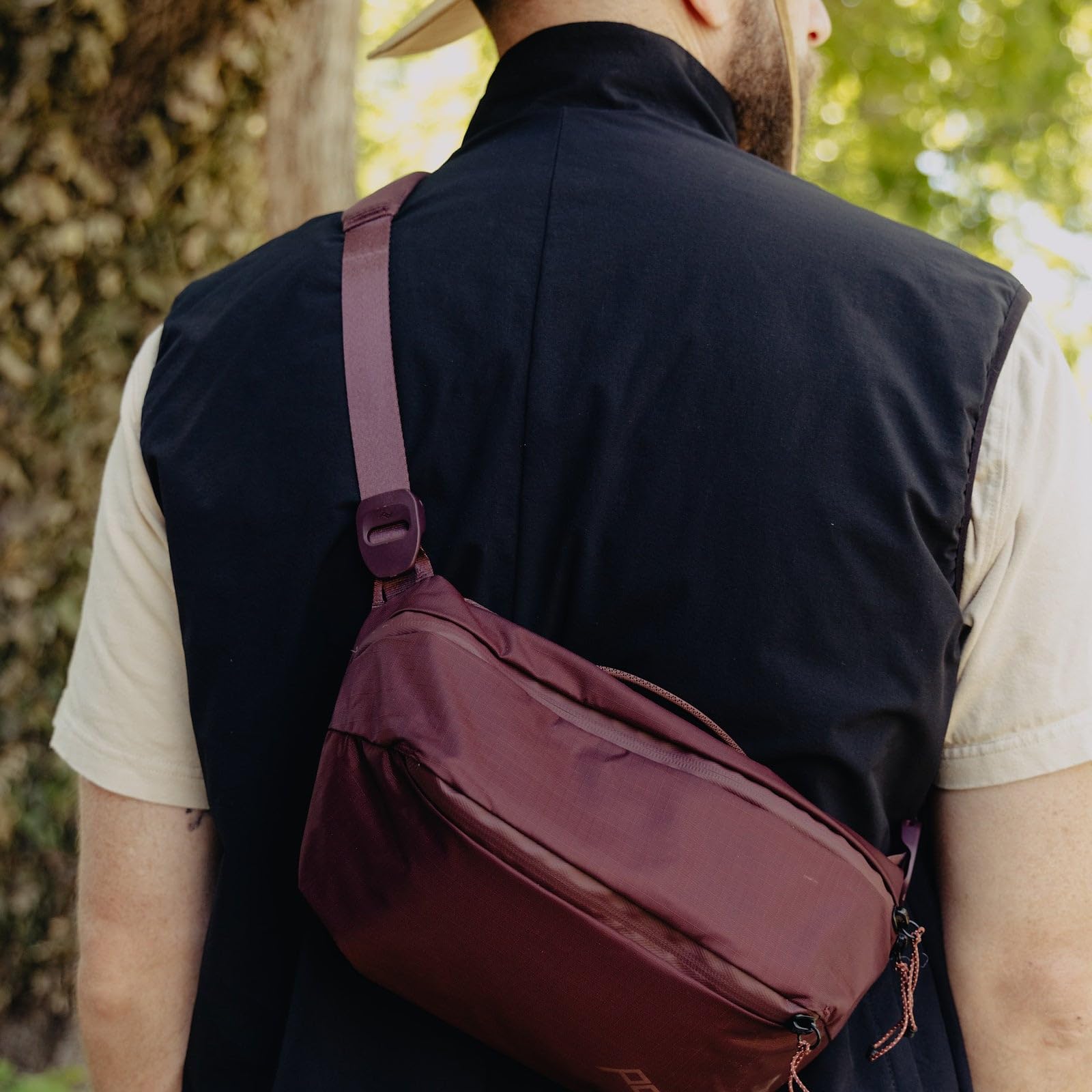 Peak Design Outdoor Sling 2L Eclipse worn at the waist for hands-free movement