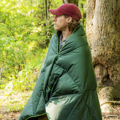Pelican Outdoor Woobie Poncho conversion shown for versatile shelter and warmth around a campfire.