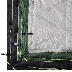 Pelican Woobie water-resistant shell demonstrated during light rain and rugged outdoor use.