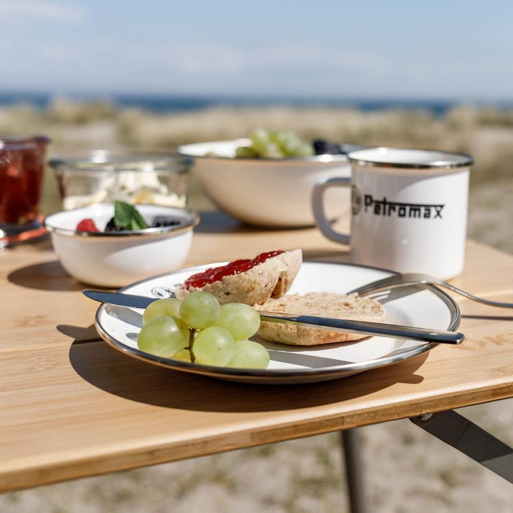 Petromax enamelware plate outdoors scene highlights lightweight design