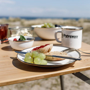 Petromax enamelware plate outdoors scene highlights lightweight design