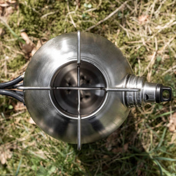 Petromax Fire Kettle fueled by twigs for outdoor cooking