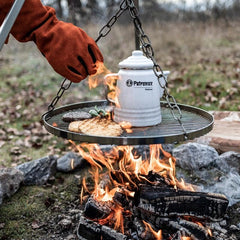 Petromax raised-edge surface keeps food in place while grilling.