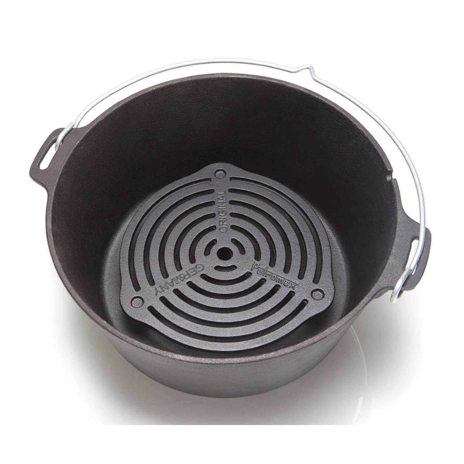 Petromax Stack Grate placed on fire for versatile heat control.