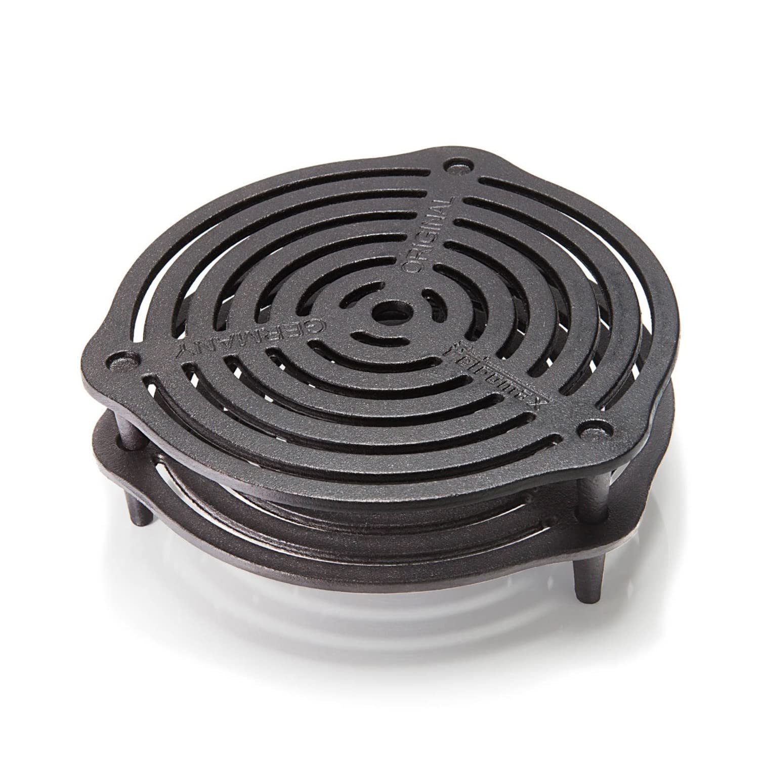 Petromax Stack Grate on table provides rustic protection for dining surfaces.