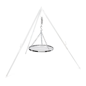 Petromax steel chains and grate swinging to gently cook over fire.