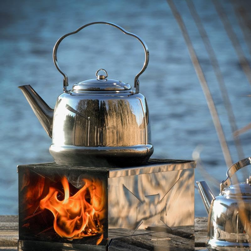 Petromax teakettle ready for camping, attached to a backpack for easy transport.