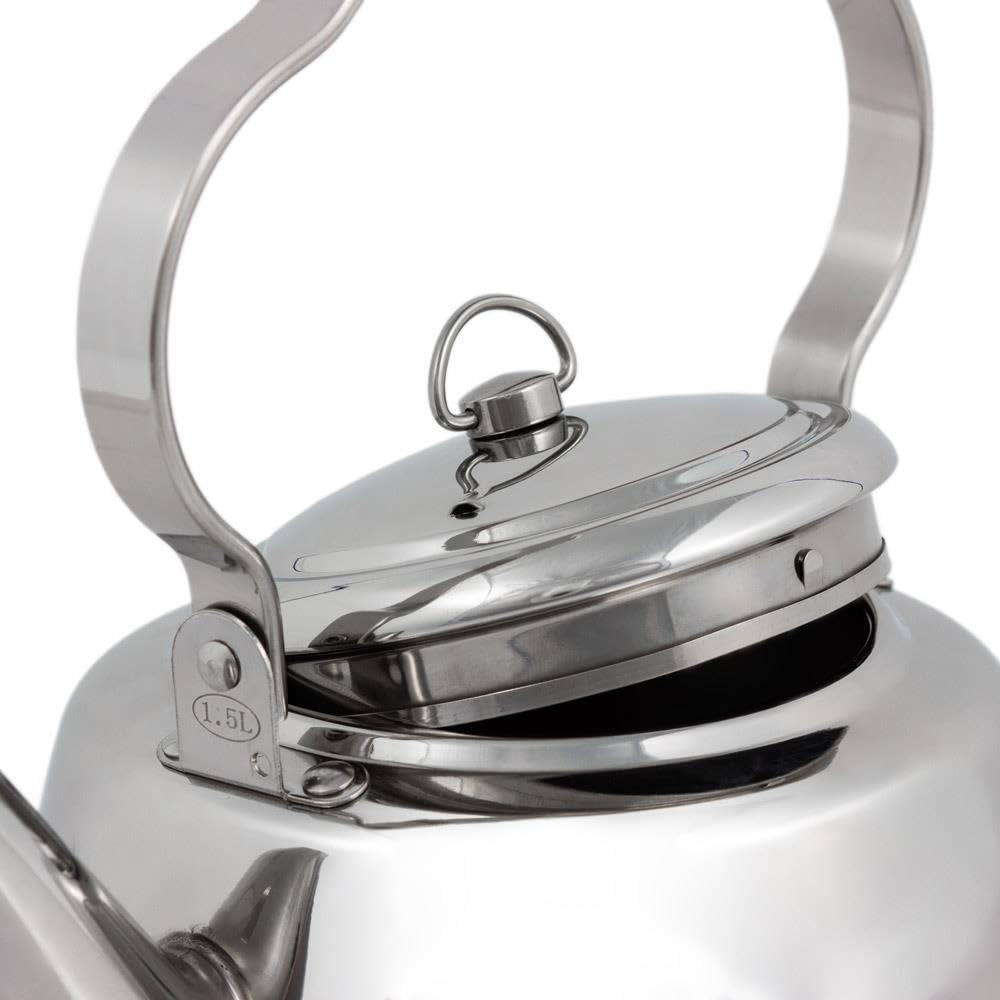 Petromax teakettle nestled in embers for warming drinks outdoors