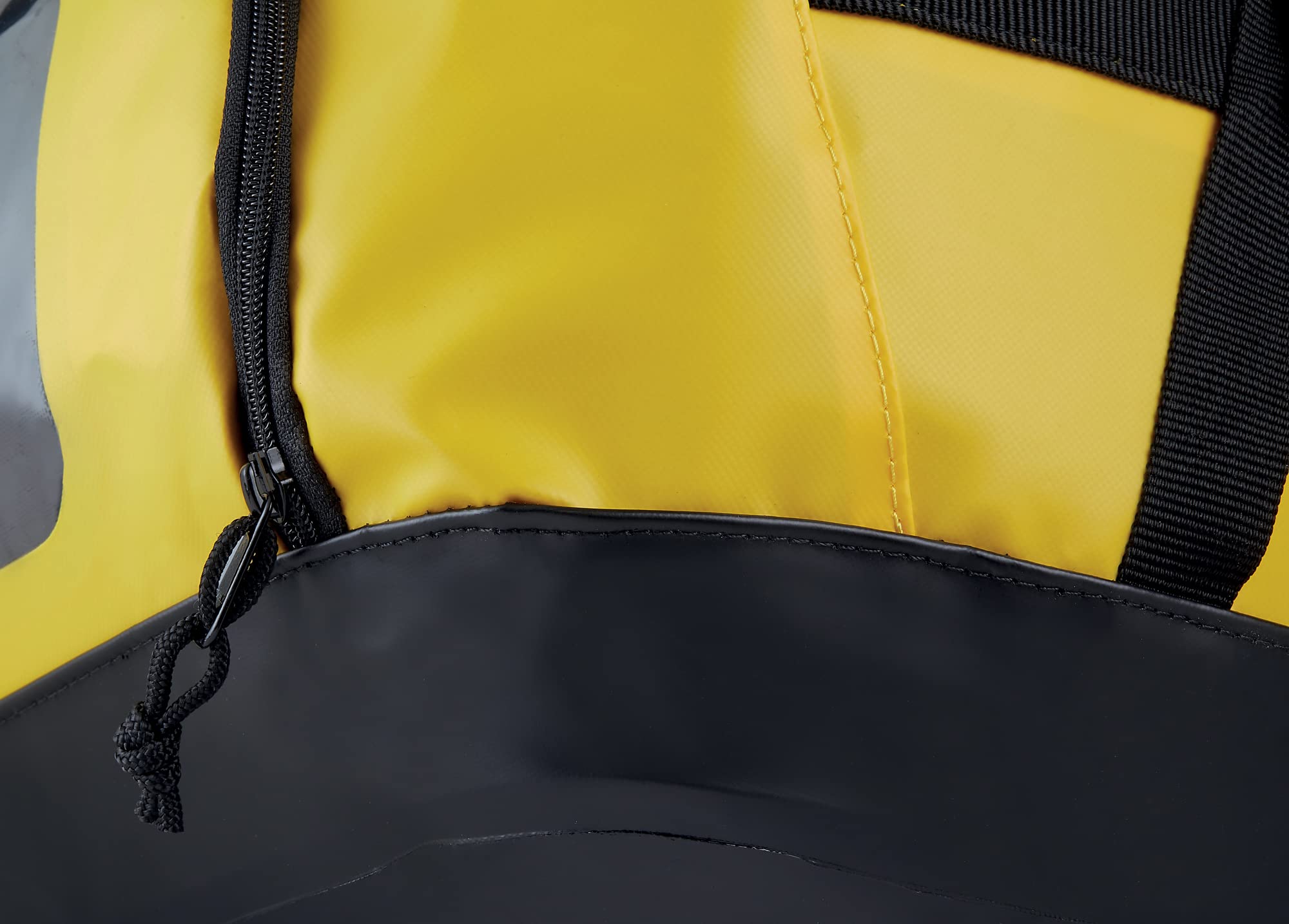 Petzl Duffel 65 side pocket stores helmet or shoes for separate storage.