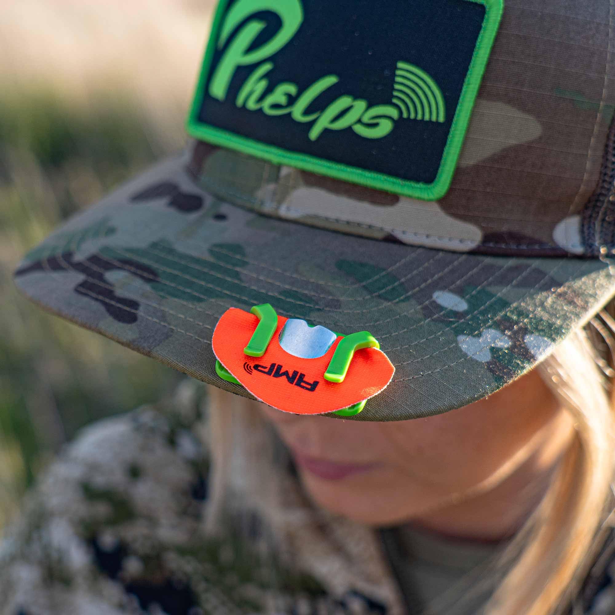 Phelps Diaphragm Hat Clip on binocular straps for quick access.